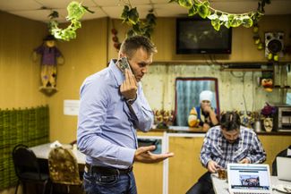 In the summer of 2015, Navalny tried to organize a new opposition coalition with Mikhail Kasyanov of the Parnas party and Mikhail Khodorkovsky of Open Russia. The coalition’s first goal was to win parliamentary elections in several Russian regions, but the opposition candidates were allowed on the ballot in only one region, and only a few weeks before elections. Navalny held a few rallies in the region, but the opposition lost, receiving just over 2 percent of the vote. The photograph shows Navalny and his associate, Leonid Volkov, doing campaign business at a roadside restaurant, September 4, 2015.